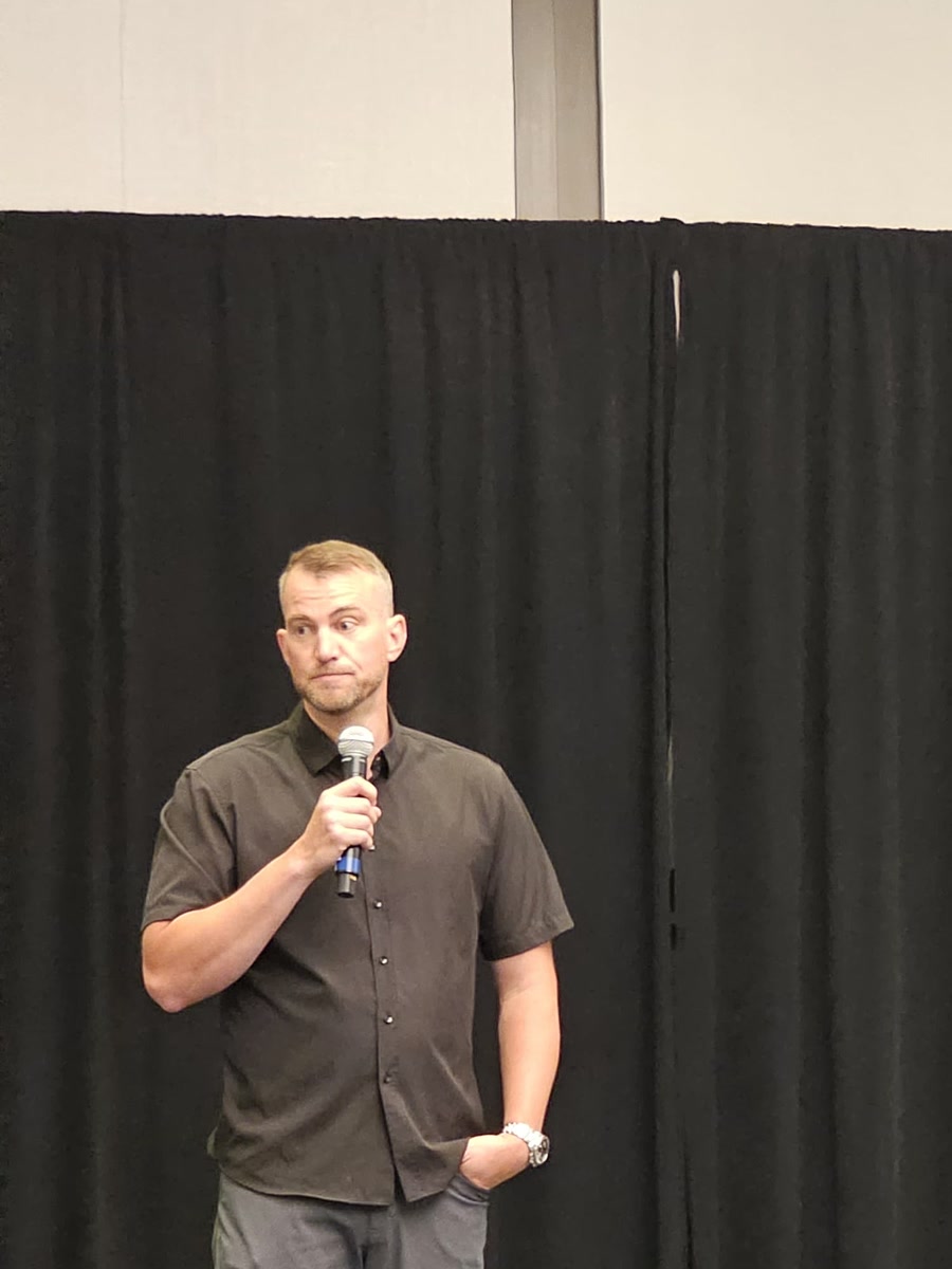 Andrew Malm on stage at an investor event